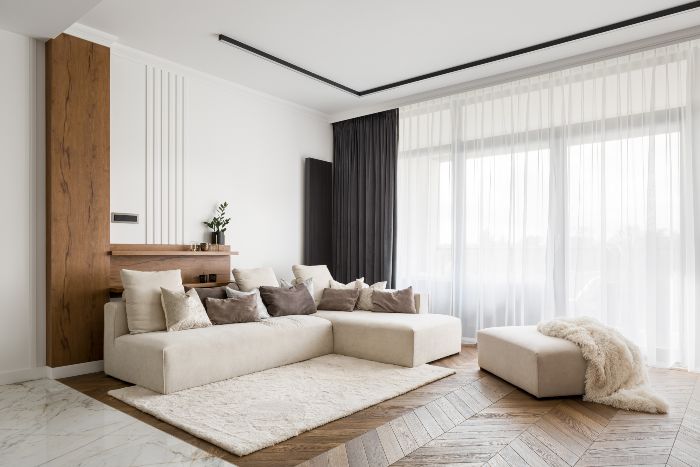 Modern living room with beige sectional sofa.