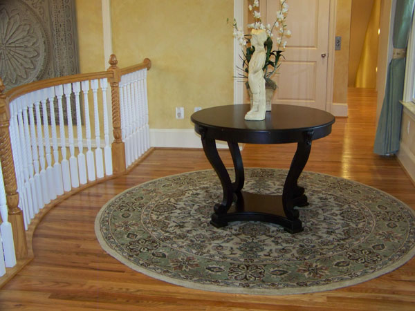 Round table and area rug in entryway.