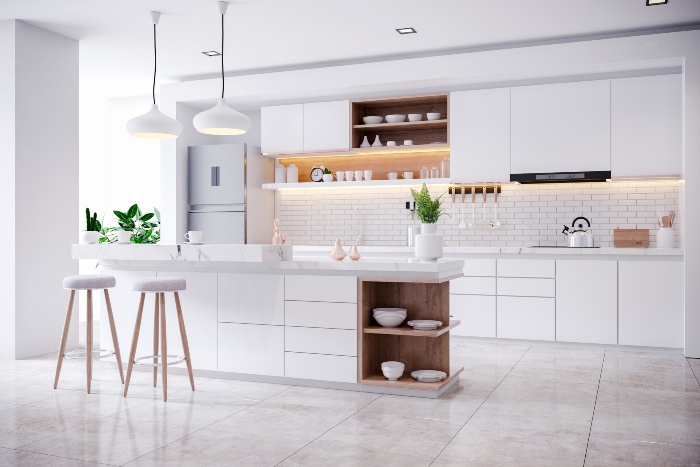 Modern white kitchen with island and stools.