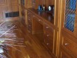 Here's an alt tag for the image: Ornate wooden cabinetry and drawers.