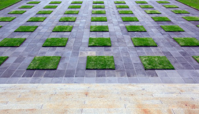 Here's an alt tag for the image: Stone path with inlaid grass squares.
