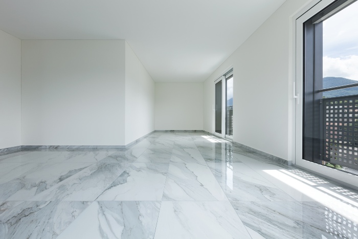 Empty room with marble floor and view.