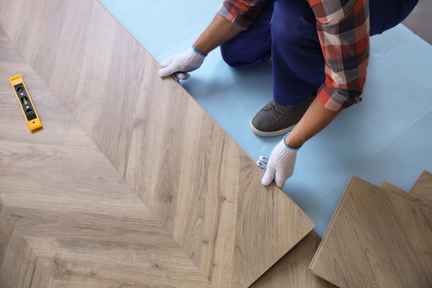 A man installing wood flooring by Elegant Floor Services in the Washington Metro Area