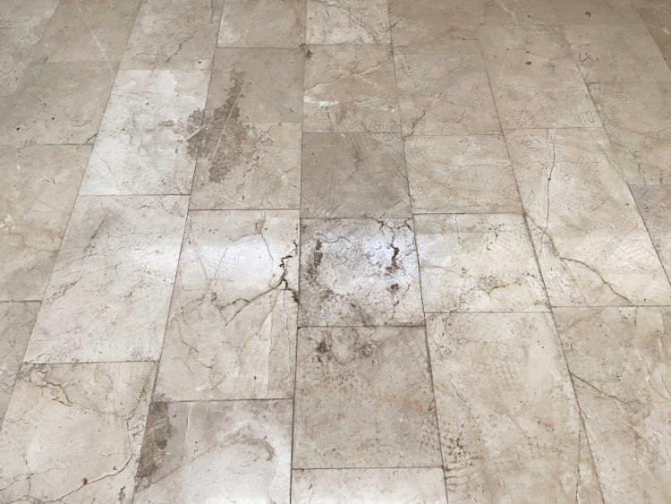 A worn stone flooring needing professional refinishing at Elegant Floor Services